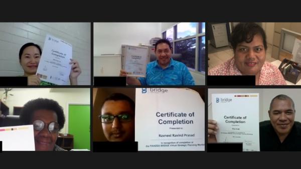 Workshop participants holding their certificates 